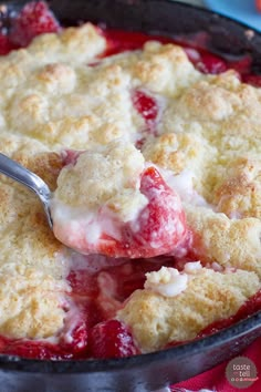 a strawberry cobbler with a spoon in it