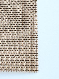 a piece of woven material on a white surface with no background or image to describe