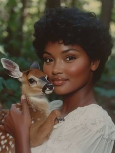 a woman holding a small deer in her arms