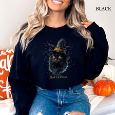 Black Cat Lovers...this is for you! Embrace the spooky season with this cozy Gildan crewneck sweatshirt, featuring an adorable Black Cat, wearing a witch's hat. The ideal gift for anyone who loves Black Cats & Halloween - from Black kitty moms, dads & grandmas, to kids & teenagers with pet cats. Fall themed, but cute for year round!  Want a different color? This design looks great on almost any color. Message me & I'll see if I can make something you love!  I am open to any sort of customization Spooky Black Halloween Sweatshirt, Black Long Sleeve Sweatshirt With Cat Design, Black Crew Neck Sweatshirt With Cat Design, Spooky Kitty, Cats Halloween, Black Cat Lover, Cat Mama, Black Kitty, Pet Cats