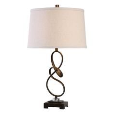 a table lamp with a white shade on the top and a black base, in front of a white background