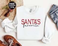 Santa's Favorite Christmas Sweatshirt, Embroidered Santa Christmas Sweatshirt, Vintage Crewneck Xmas Sweatshirt, Christmas Eve Gift for Him ⭐ Item Specifications: 🟉 50% Polyester 50% Cotton 🟉 Reactive Dyed 🟉 Set in Sleeve 🟉 300gsm 🟉 Lycra Ribbed Cuffs, Welt & Neck 🟉 Twin Needle Stitching at Neck, Shoulders, Armhole+ 🟉 Brushed Effect for Superior Comfort & Look 🟉 Contemporary Fit 🟉 Please note this is the price for single sweatshirt We excel in delivering superior quality and value in pe Christmas Crew Neck Sweatshirt With Embroidered Graphics, Casual Christmas Sweatshirt With Custom Embroidery, Christmas Long Sleeve Sweatshirt With Embroidered Text, Black Christmas Sweatshirt, Christmas Believe Sweatshirt, Christmas Eve Gift, Vintage Crewneck, Embroidery Sweatshirt, Garment Labels