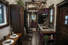 a narrow kitchen and dining area in a tiny home