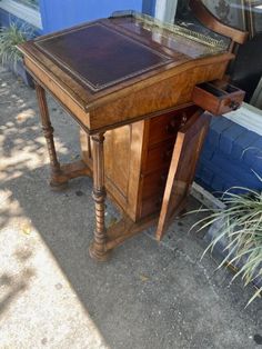 an old wooden desk sitting next to a window