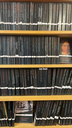 the shelves are full of books with pictures on them, and one has an image of a woman's face