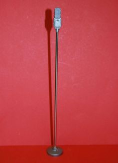 a toothbrush on a stand against a red wall