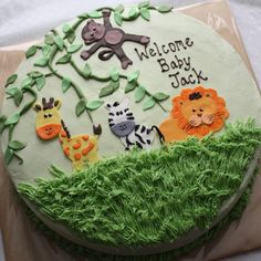 a baby shower cake decorated with jungle animals