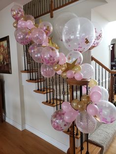 balloons and streamers are hanging from the banister