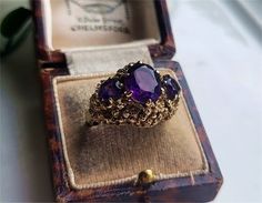 an antique amethyst ring sits in its box