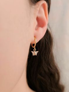 "These dainty earrings are made with cubic zirconia butterfly charms and 18 karat gold plated huggie hoops. This gold plating protects against wear and tear, tarnishing, and light contact with substances such as water. Closures: * Pierced gold hoops are hypoallergenic and nickel free (18 karat gold plated). * Clip on gold hoops are hypoallergenic and nickel free (18 karat gold plated). Dimensions: 0.87\" × 0.3\" How to wear clip ons: Hold the earring in one hand while pulling the closure open with the other hand, place the earring onto the thin upper earlobe, then slide the earring down the earlobe to secure in place. Please feel free to message me for any questions!" Butterfly Earring, Earrings Butterfly, Diamond Butterfly, Huggie Earrings, Butterfly Charm, Butterfly Earrings, Dainty Earrings, Gold Hoops, Gorgeous Earrings