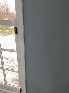 an open door with snow on the ground