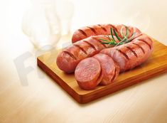 sliced sausages on a cutting board with rosemary