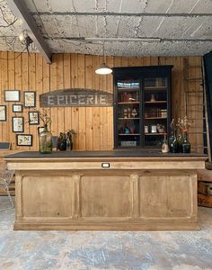 an empty bar with wooden paneling and pictures on the wall