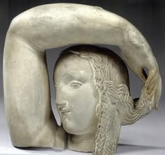 a sculpture of a woman holding her head