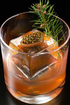 A clear, low ball glass filled with one large ice cube that has a mini pine cone on top and a sprig from a pine tree behind it. A brownish-red mixture fills half the glass. Pine Syrup, Christmas Old Fashioned, Winter Flavors, Pomegranate Liqueur, Maple Whiskey, Citrus Garnish, Classic Old Fashioned, Cocktail Recipes Whiskey, Pear Cider