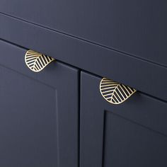 an image of a blue cabinet with gold handles and knobs on the front door