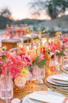 the table is set with flowers and candles