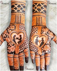 two hands with henna designs on them