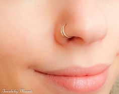 a woman's nose with a gold nose ring on top of her nose and the words regular price $ 59 00