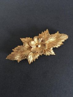 Andriani Vintage is pleased to offer for sale this wonderful  vintage Brooch. A wonderful Gold Gilt Look Brooch PinIn a floral design  with leaves In lovely vintage condition9.5cms.  X 4cms Great unusual items at a very affordable price. Gold Flower Brooch For Evening, Antique Flower Brooches For Wedding, Handmade Vintage Brooches For Anniversary, Gold Brooch With Flower Decoration For Formal Occasions, Handmade Vintage Brooch For Anniversary, Handmade Vintage Brooches For Vintage Events, Vintage Gold Flower Brooches, Vintage Gold Flower Brooch, Gold Retro Wedding Brooches