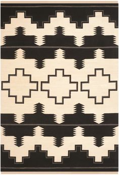 a black and white rug with geometric designs on it's sides, in the shape of an arrow