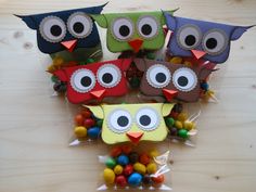 four owls made out of candy on top of a wooden table