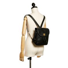 This beautiful Chanel Triple CC backpack has a black caviar leather body with the signature Triple CC stitching along the bottom of the Bag, flat leather straps with gold-tone detailing, a flap with gold-tone interlocking Cs, and a twist closure. The Bag also features a drawstring closure and zippered compartments inside. Chanel Backpack, Ysl Shoes, Gucci Watch, Versace Watch, Gold Chanel, Jimmy Choo Sunglasses, Chanel Caviar, Fendi Shoes, Black Caviar