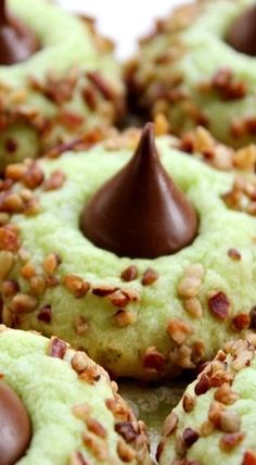 green cookies with chocolate and nuts on top