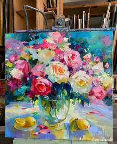 a painting of flowers in a vase on an easel