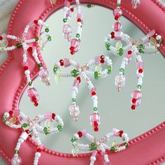 a pink tray with beaded decorations on it