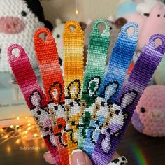 a person holding up some colorful beaded items