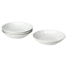 three white bowls sitting next to each other on top of a white tableware set