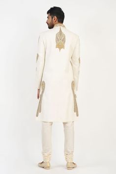 Ivory matka silk sherwani with dabka, beads and french knots hand embroidered motifs. Comes with churidar and a kurta. - Aza Fashions Ceremonial Cream Nehru Jacket With Zari Work, Ceremonial Cream Bandhgala With Chikankari Embroidery, Ceremonial Cream Raw Silk Kurta, Elegant Off White Embroidered Sherwani, Elegant Embroidered Off White Sherwani, Elegant Off-white Embroidered Sherwani, Ceremonial Off White Kurta With Resham Embroidery, Ceremonial Cream Kurta With Intricate Embroidery, Designer Nehru Jacket With Intricate Embroidery In Cream