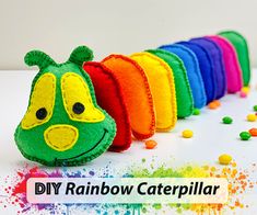 a rainbow caterpillar stuffed animal sitting on top of a table