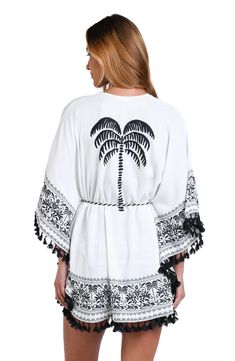 This black and white monochromatic print features an allover tropical motif perfect for any vacation destination. Tassel trim gives this cover-up a playful style that is at once carefree and put together. The square, belted front is offset by loose-fitting butterfly sleeves for a decidedly feminine silhouette. [split] Details Kimono cover-up Square, belted front Breezy butterfly sleeves Black/Ivory rope and black tassel trim Fabric 100% Polyester White Tie Waist Swimwear For Beach, White Swimwear With Tie Waist For Beach, White Tie Waist Swimwear For Beach Season, White Swimwear With Tie Waist For Beach Season, White Summer Swimwear With Tie Waist, White Tie Waist Summer Swimwear, White Tropical Print Cover-up, White Tropical Style Cover-up With Tropical Print, White Cover-up For Resort Season