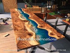 a table that is made out of wood and has blue paint on it with the words,