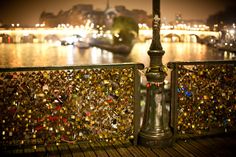 the bridge is covered with many padlocks