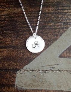 "Sterling Silver Initial Necklace Initial Charm Necklace Initial Necklace Monogram Necklace Bridesmaid Gift Gift for Mom Handstamped Necklace This Handstamped Sterling Silver Initial Necklace will make a great gift to any woman in your life. This listing includes: *One Sterling Silver Disc(18mm 22 gauge) with hammered edge stamped with the letter of your choice *One 18\" Sterling Silver Curb Chain * All components are .925 Sterling Silver Samples shown are stamped in 6mm Monogram at check-out, p Simple Hand Stamped Necklace As Gift, Hand Stamped Charm Necklace With Round Pendant, Hand Stamped Charm Necklace With Round Pendant For Gift, Dainty Hand Stamped Necklaces For Personalized Gift, Dainty Hand Stamped Necklace For Personalized Gift, Hand Stamped Round Pendant Charm Necklace For Gift, Elegant Hand Stamped Initial Pendant Necklace, Simple Engraved Initial Pendant Jewelry, Simple Engraved Charm Necklaces For Gifts