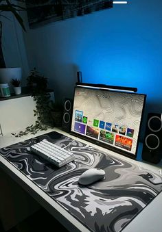 a computer desk with a mouse and keyboard on it in front of a blue wall