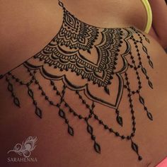 the back of a woman's stomach with an intricate design on it