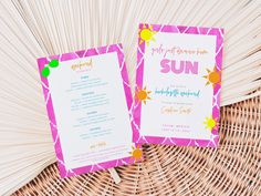 two pink and yellow wedding programs sitting on top of a wicker basket next to each other