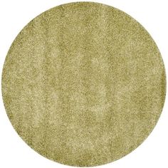 a round area rug with an oval design on the top and bottom, in light green