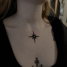 a woman's chest with a star tattoo on it