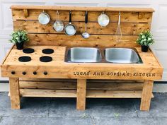 an outdoor kitchen made out of pallets with pots and pans on the top