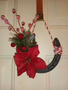 a christmas wreath with candy canes and poinsetti