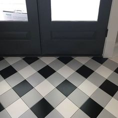 a black and white checkered floor with two doors