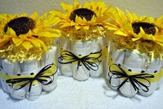 three baby diapers with sunflowers in them