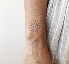 a person's arm with a small tattoo on the left side of their arm