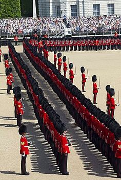 a group of men in red uniforms standing next to each other