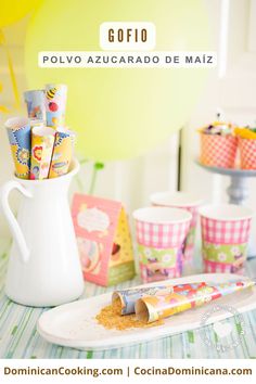 a table topped with lots of different types of food and drink cups next to each other